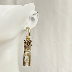 CC TEXT DIAMOND PAVED LIGHT GOLD DROP EARRINGS