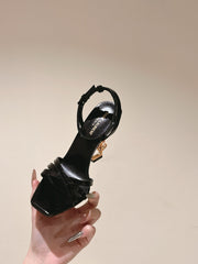 YSL 25S HIGH-HEEL SANDALS 100 MM IN BLACK GLOSSY LAMBSKIN WITH YSL LOGO HEEL DESIGN IN GOLD