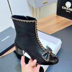 CHANEL 25S HEELED CHAIN BOOTS WITH BOW IN BLACK CALFSKIN GOLD HARDWRE