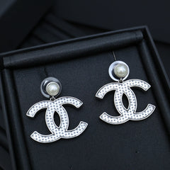 DOUBLE C EARRINGS IN SILVER METAL WITH BLACK SNOWFLAKE EMBOSSED ON WHITE ENAMEL