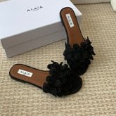 ALAIA FLAT MULE IN BLACK SUEDE