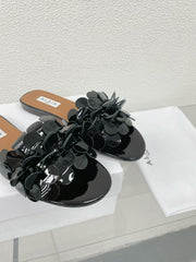 ALAIA FLAT MULE IN BLACK GLOSSY LAMBSKIN