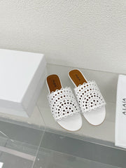 ALAIA VIENNE FLAT MULES IN WHITE LAMBSKIN