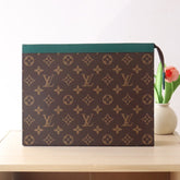 LV 25S POCHETTE VOYAGE 26 IN BORNEO GREEN MONOGRAM MACASSAR COATED CANVAS