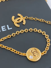 TWISTED CHAIN BELT WITH RHINESTONES AND LOGO PLATE IN GOLD TONE