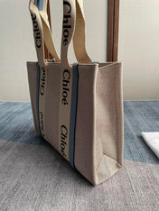 MEDIUM STRAP WOODY TOTE BAG 37 IN BEIGE LINEN CANVAS BLACK WEBBING LOGO EMBROIDER BLUE CALFSKIN