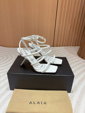 ALAIA THREE-STRAPS HIGH HEEL SANDALS IN WHITE PATENT LAMBSKIN