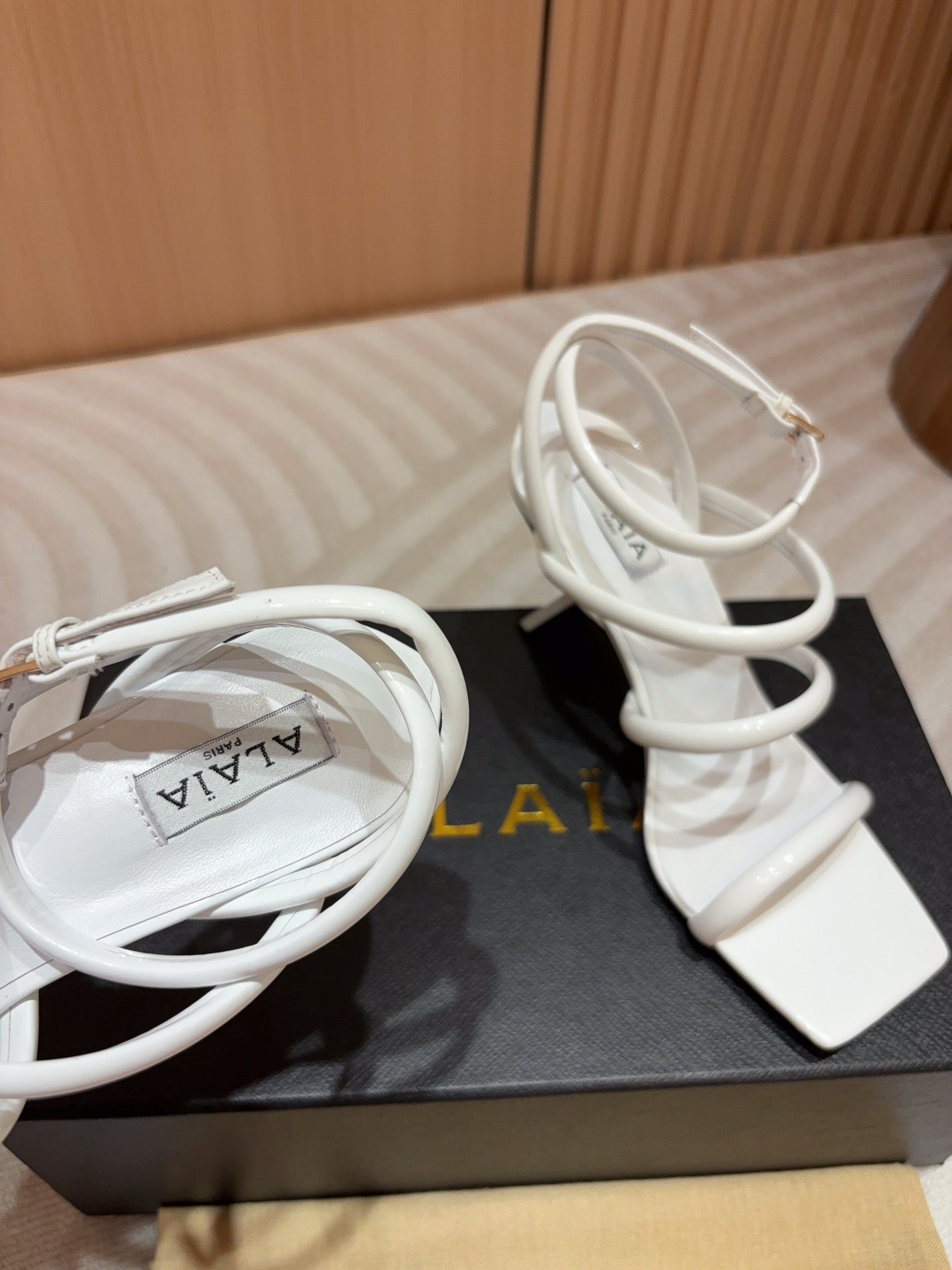 ALAIA THREE-STRAPS HIGH HEEL SANDALS IN WHITE PATENT LAMBSKIN