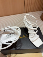 ALAIA THREE-STRAPS HIGH HEEL SANDALS IN WHITE PATENT LAMBSKIN