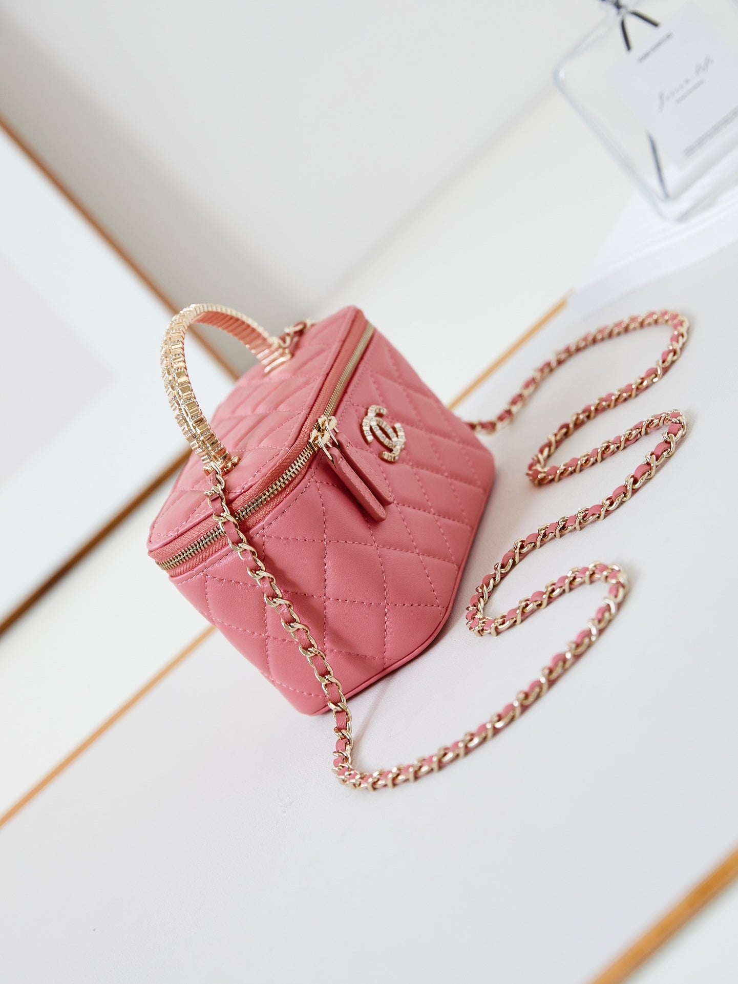 CHANEL 25S MINI VANITY BAG 16 CM IN PEACHY PINK LAMBSKIN WITH CRYSTAL-EMBELLISHED CC LOGO