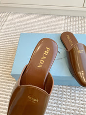 MULES IN BROWN GLOSSY SHEEPSKIN GOLD LETTERING LOGO