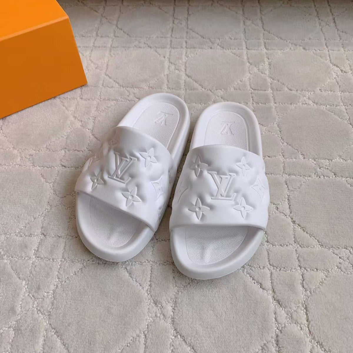 LV EMBOSSED POOL PILLOW SANDALS IN WHITE RUBBER