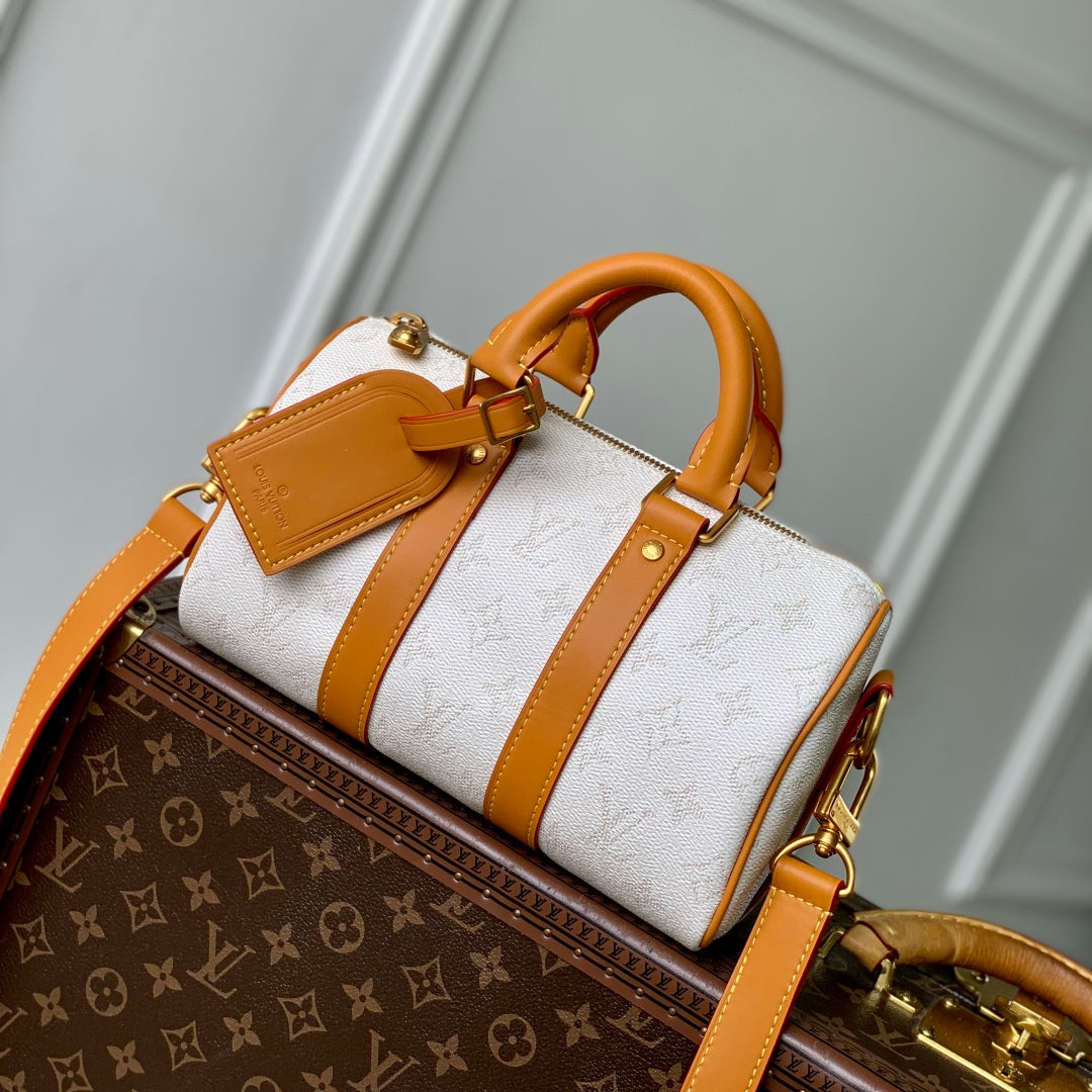 KEEPALL BANDOULIÈRE 25 IN WHITE MONOGRAM HERITAGE CANVAS BRWON CALFSKIN