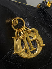 DIOR 25S SMALL VOYAGE BAG 23 IN BLACK FLAT MACROCANNAGE GRAINED GLOSSY CALFSKIN