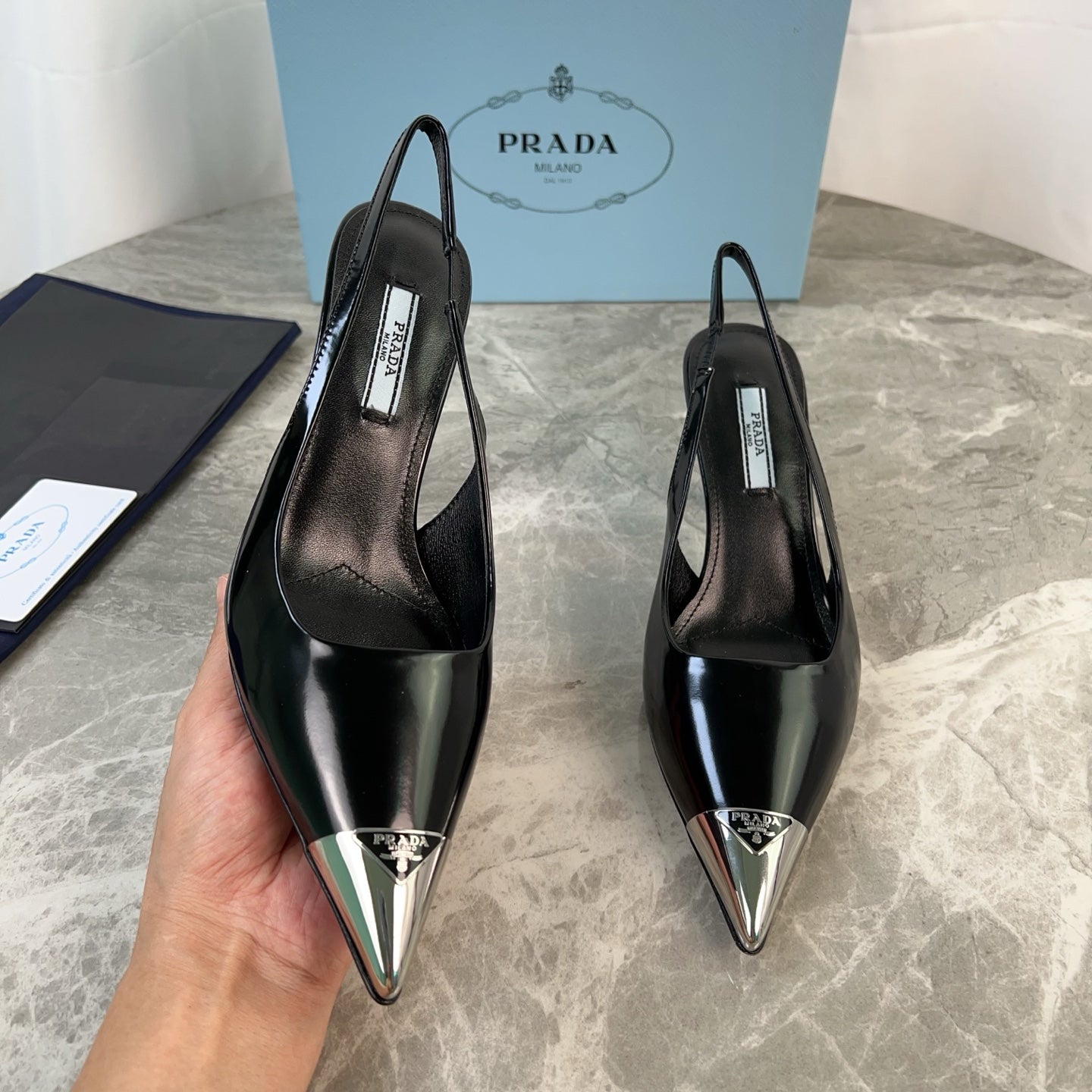 PRADA 25S METAL-TOE SLINGBACK PUMPS IN BLACK CALFSKIN