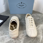 PRADA 25S MONTECARLO ANTIQUED SNEAKERS IN CHALK WHITE NAPPA LEATHER