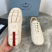 PRADA 25S MONTECARLO ANTIQUED SNEAKERS IN CHALK WHITE NAPPA LEATHER