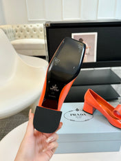 SQUARE TOE PUMPS IN INTERNATIONAL ORANGE GLOSSY CALFSKIN ATTACHED BOW