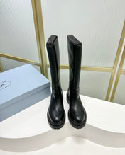 KNEE BOOTS WITH TRIANGLE LOGO IN BLACK CALFSKIN