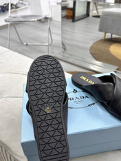 PRADA 25S SLIDE SANDALS IN BLACK CALFSKIN LOGO