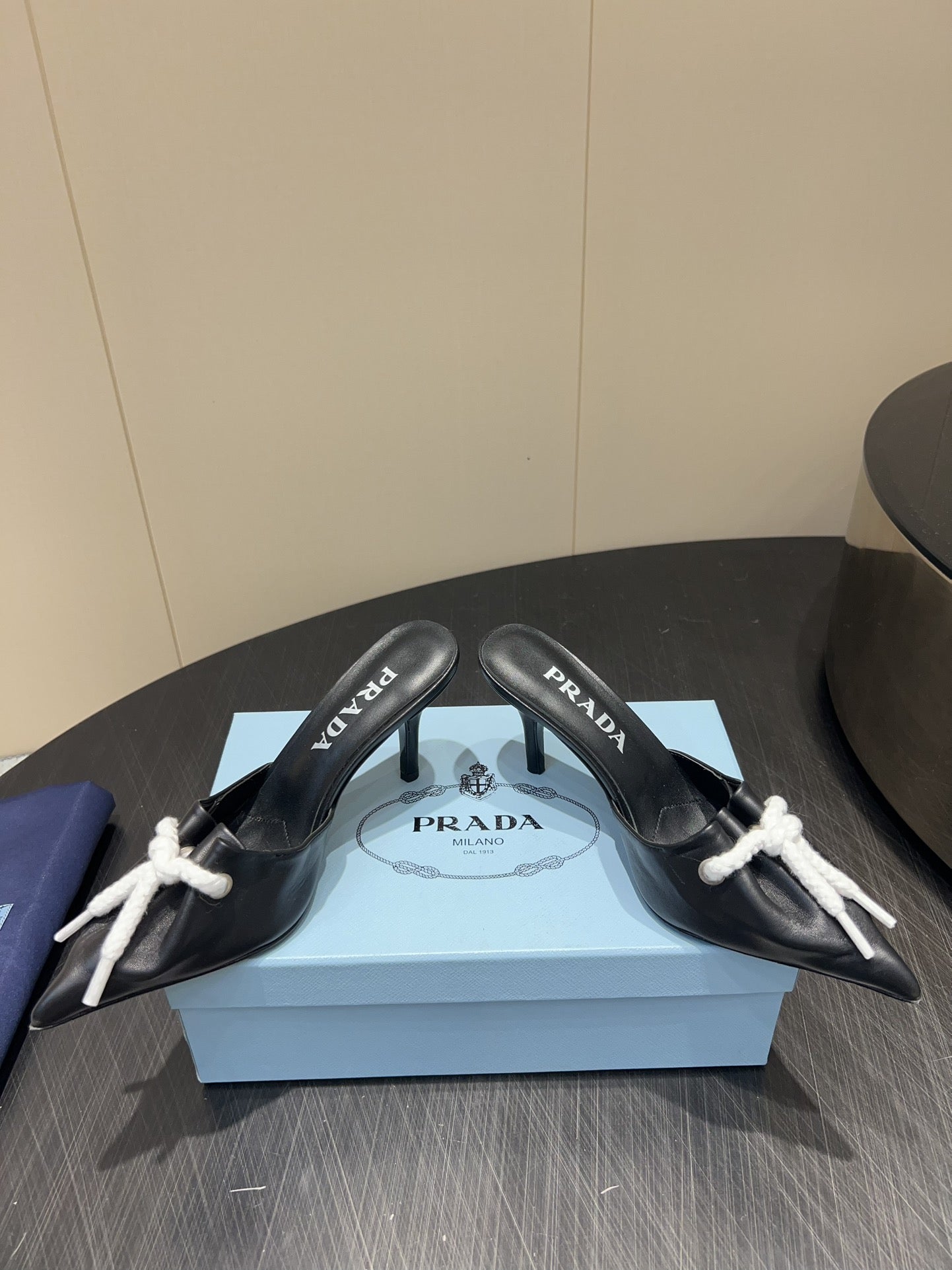 PRADA 25S BRAIDED DETAIL MULES 85MM IN BLACK CALFSKIN