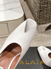 ALAIA SPIKE JEWEL MULES IN WHITE CALFSKIN