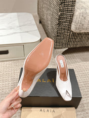 ALAIA SPIKE JEWEL MULES IN WHITE CALFSKIN