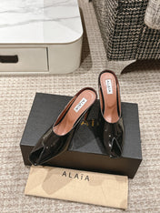 ALAIA SPIKE JEWEL MULES IN BLACK GLOSSY CALFSKIN